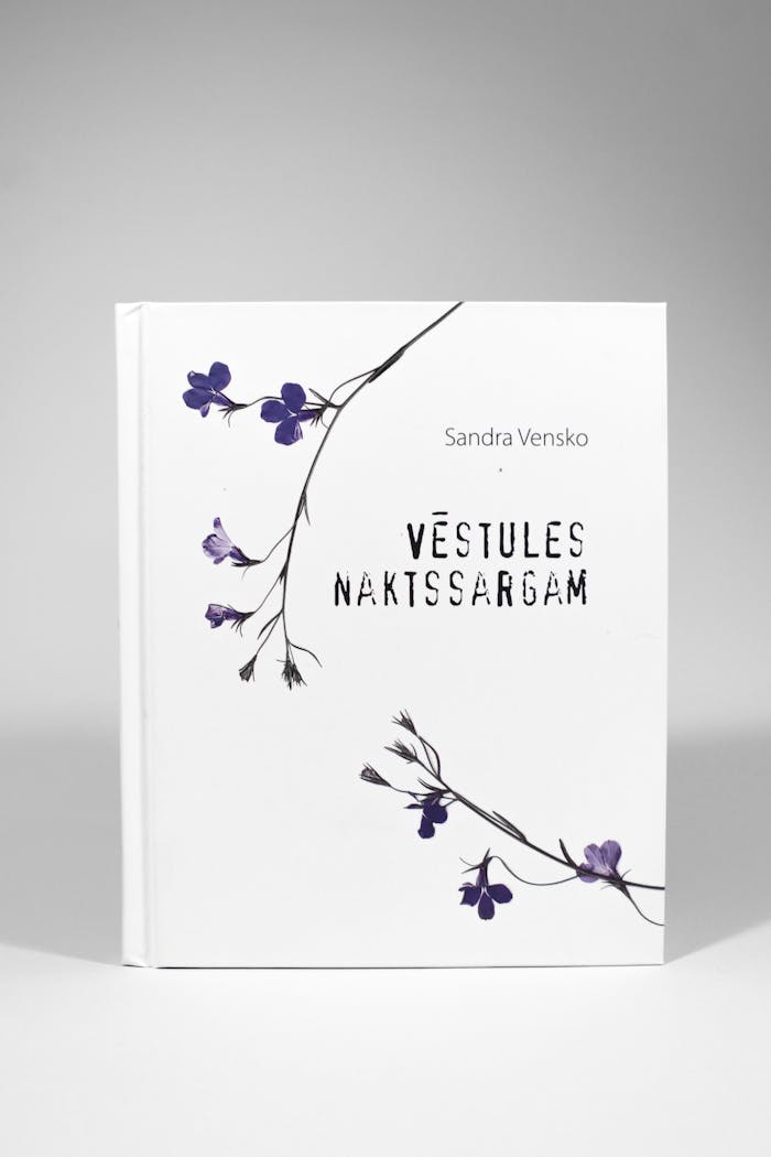 Hardcover book 'Vēstules Naktssargam' with delicate floral design on white background.