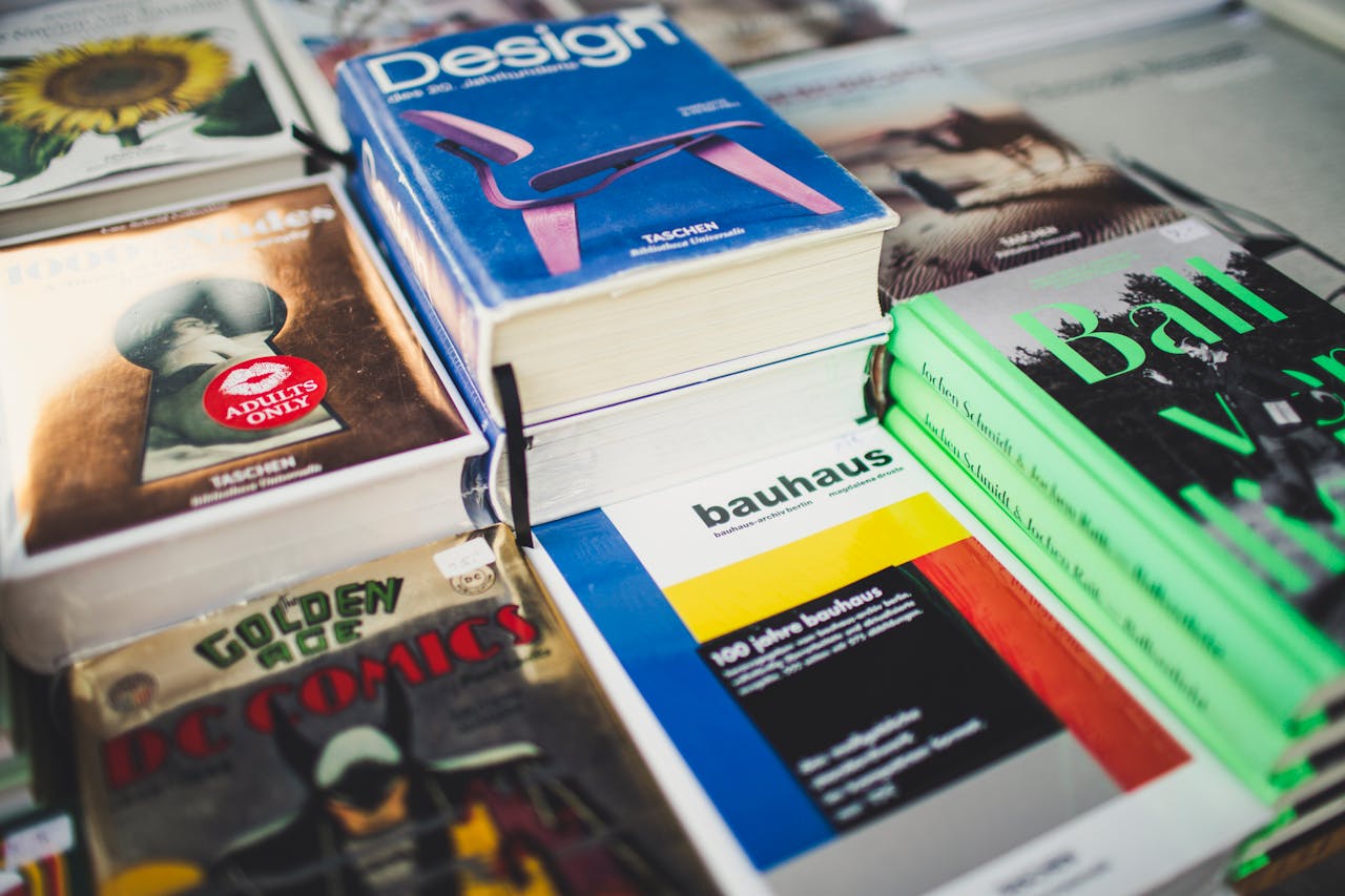 A colorful array of books on design and literature, perfect for art lovers and comic enthusiasts.